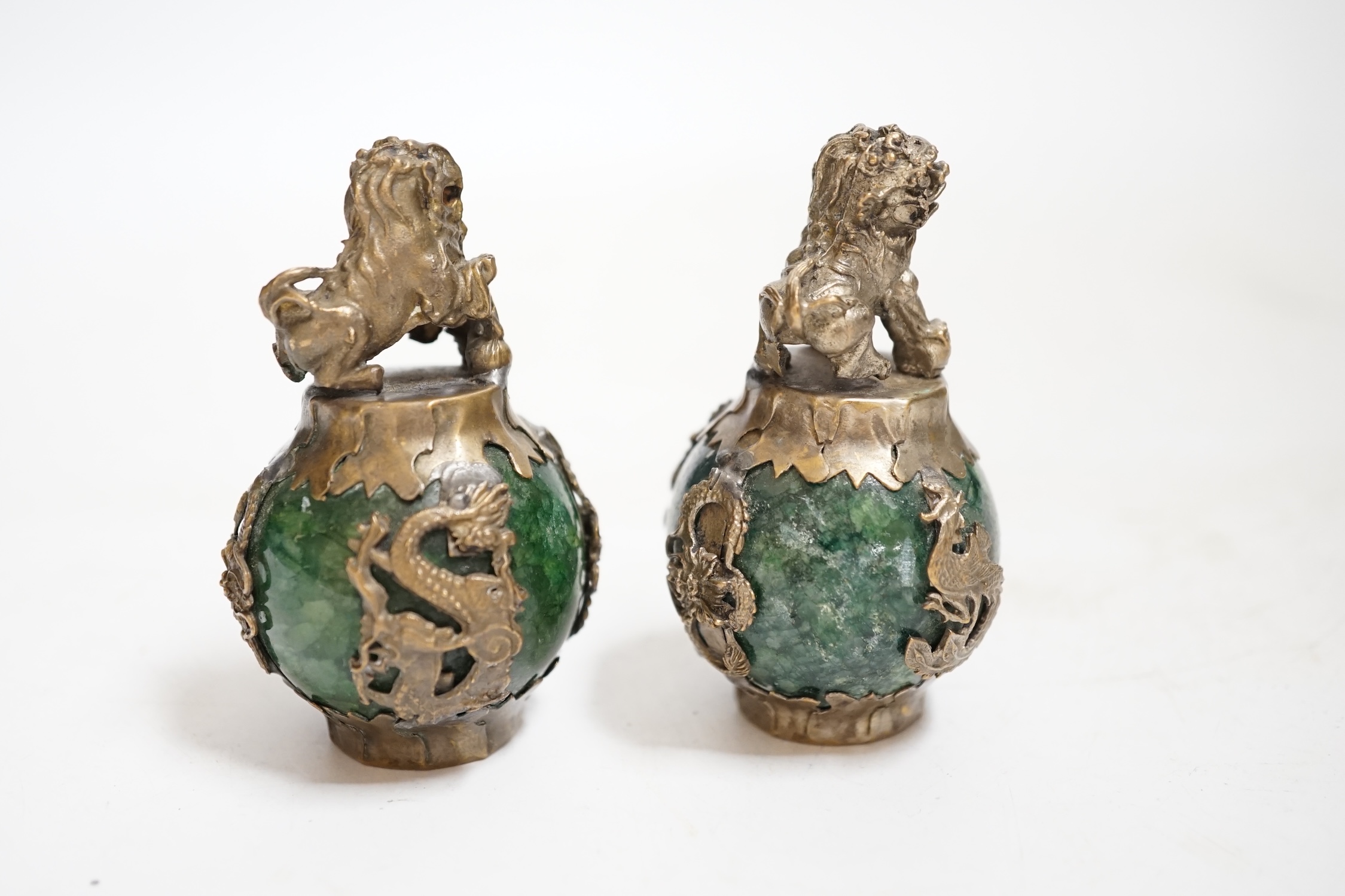 A pair of Chinese Buddhist lion hardstone and brass mounted paperweights, 7cm high., Condition - fair